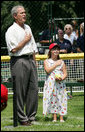 President George W. Bush is joined for the singing of the national anthem by Meredith Cripe, a member of the Chantilly, Virginia Little League Challenger League, at the top of the first White House Tee Ball Game of the 2007 season. The game pitted the Bobcats from Cumberland, Maryland, against the Red Wings of Luray, Virginia. White House photo by Eric Draper