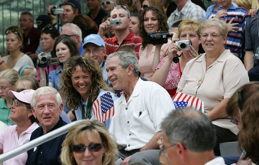 President George W. Bush joins honorary tee ball commissioner and two-time Olympic gold medalist Michele Smith on the South Lawn sidelines of the 2007 White House Tee Ball season opener Wednesday, June 27, 2007. The game matched the Red Wings of Luray, Virginia against the Bobcats of Cumberland, Maryland. White House photo by Eric Draper
