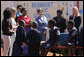 Mrs. Laura Bush and Ms. Jenna Bush stand with Zambian First Lady Mrs. Maureen Mwanawasa, dressed in red, and her daughter Ms. Chipo Mwanawasa, far left, as they watch children demonstrate how the PlayPump works at the Regiment Basic School Thursday, June 28, 2007, in Lusaka, Zambia. Working similar to a merry-go-round, the PlayPump pumps clean drinking water into a reservoir tank as the children sit on and spin it. Before the pump was installed many of the 1,200 students at the school had to bring water to school or walk long distances to find water. The school also has used the water to expand its garden, providing fresh vegetables to the more vulnerable students. White House photo by Lynden Steele