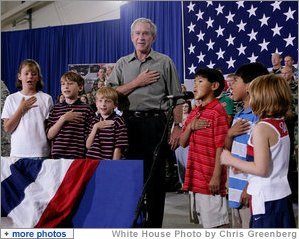 President George W. Bush joins a group of children during the Pledge of Allegiance Wednesday, July 4, 2007, at a Fourth of July visit with members of the West Virginia Air National Guard 167th Airlift Wing and their family members in Martinsburg, W. Va. White House photo by Chris Greenberg