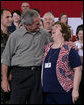 President George W. Bush embraces Joy Enders, president of the 167th Airlift Wing Family Readiness Group, Wednesday, July 4, 2007, during a Fourth of July visit with members of the West Virginia Air National Guard 167th Airlift Wing and their family members in Martinsburg, W. Va. President Bush thanked Enders and members of her organization for their mission to care for the families of deployed Guard members. White House photo by Chris Greenberg