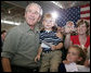 President George W. Bush poses for photos during his visit Wednesday, July 4, 2007, with members of the West Virginia Air National Guard 167th Airlift Wing and their family members in Martinsburg, W. Va. White House photo by Chris Greenberg