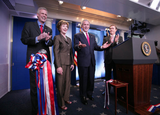 President George W. Bush and Mrs. Laura Bush, with White House Press Secretary Tony Snow, left, welcome reporters and photographers back to the newly re-modeled James S. Brady Press Briefing Room following an official ribbon cutting, Wednesday, July 11, 2007, at the White House. White House Correspondents' Association president Steve Scully is seen at right. White House photo by Eric Draper