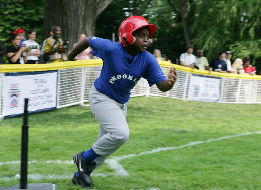 A player from the Inner City Little League of Brooklyn, N.Y. runs for first base after his hit against the Wrigley Little League Dodgers of Los Angeles Sunday, July 15, 2007 at the White House Tee Ball Game, in honor of legendary baseball player Jackie Robinson. More about Tee Ball on the South Lawn. White House photo by Chris Greenberg