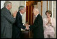 President George W. Bush congratulates Dr. Norman Bourlag during the Congressional Gold Medal Ceremony honoring the doctor's efforts to combat hunger Tuesday, July 17 , 2007, at the U.S. Capitol. Also pictured is House Majority Leader Steny Hoyer, left, and Speaker of the House Nancy Pelosi. White House photo by Chris Greenberg