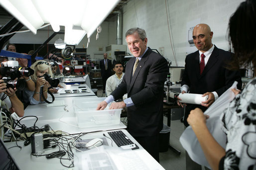 President George W. Bush tries out a keyboard that types underwater at Man & Machine, Inc. during a tour with CEO Clifton Broumand Wednesday, July 18, 2007, in Landover, Md. Man & Machine, Inc. makes water-resistant computer accessories for hospitals, medical laboratories, and industrial environments. White House photo by Chris Greenberg