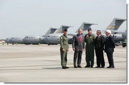 President George W. Bush talks with Colonel Mark Bauknight, acting Commander of the 315th Airlift Wing, left, and Colonel John “Red” Millander, USAF Commander of the 437th Airlift Wing, joined by Senator Lindsey Graham and Congressman Henry Brown, left, prior to observing cargo loading operations aboard a C-17 aircraft Tuesday, July 24, 2007, during a visit to Charleston AFB in Charleston, S.C. White House photo by Eric Draper