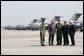 President George W. Bush talks with Colonel Mark Bauknight, acting Commander of the 315th Airlift Wing, left, and Colonel John “Red” Millander, USAF Commander of the 437th Airlift Wing, joined by Senator Lindsey Graham and Congressman Henry Brown, left, prior to observing cargo loading operations aboard a C-17 aircraft Tuesday, July 24, 2007, during a visit to Charleston AFB in Charleston, S.C. White House photo by Eric Draper