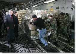 President George W. Bush, joined by South Carolina Senator Lindsey Graham, watches as USAF military personnel conduct cargo loading operations aboard a C-17 aircraft Tuesday, July 24, 2007, during a visit to Charleston AFB in Charleston, S.C. White House photo by Eric Draper
