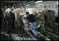 President George W. Bush, joined by South Carolina Senator Lindsey Graham, watches as USAF military personnel conduct cargo loading operations aboard a C-17 aircraft Tuesday, July 24, 2007, during a visit to Charleston AFB in Charleston, S.C. White House photo by Eric Draper