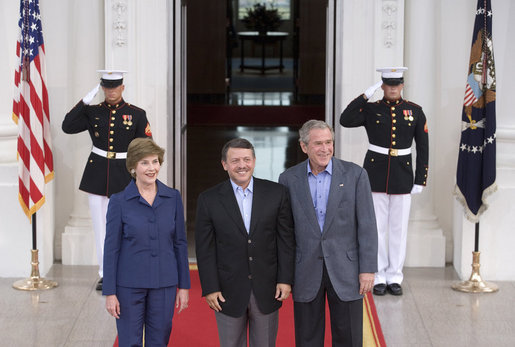President George W. Bush and Mrs. Laura Bush welcome Jordan's King Abdullah II to the White House Tuesday evening, July 24, 2007, for a social dinner. White House photo by Shealah Craighead