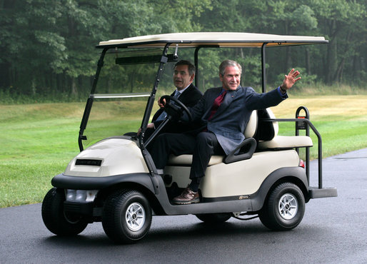 President George W. Bush waves to the media as he and Prime Minister Gordon Brown of the United Kingdom depart the landing zone at Camp David following the Prime Minister's arrival Sunday, July 29, 2007, to the presidential retreat in Thurmont, Maryland. White House photo by Eric Draper