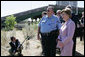 Mrs. Laura Bush surveys the wreckage of the I-35W bridge collapse with Deputy Chief of Police Robert 'Rob' Allen in Minneapolis, Friday,Aug. 3, 2007. Mrs. Bush also visited an Emergency Operation Command Center and met with volunteers and first responders. White House photo by Chris Greenberg