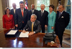 President George W. Bush signs into law H.R. 1, Implementing Recommendations of the 9/11 Commission Act of 2007, Friday, August 3, 2007, in the Oval Office.  White House photo by Eric Draper