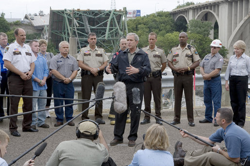 President George W. Bush talks to members of the media following his aerial and ground survey of the Interstate 35W bridge collapse in Minneapolis, Saturday, Aug. 4, 2007, where President Bush praised the work of first responders, local authorities and investigators in their response and work at the collapse scene. President Bush said he would work to help local, state and federal authorities to cut through the red tape to get the bridge rebuilt as soon as possible. White House photo by Chris Greenberg