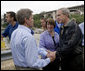 President George W. Bush shakes hands with Minnesota Senator Norm Coleman, left, and greets Senator Amy Klobuchar, (center), , at the conclusion of the President's visit Saturday, Aug. 4, 2007, to the site of the I-35W bridge collapse in Minneapolis. White House photo by Chris Greenberg