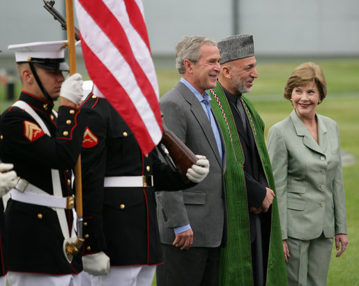 President George W. Bush and Mrs. Laura Bush stand with President Hamid Karzai of Afghanistan during an arrival ceremony at Camp David, Sunday, August 5, 2007. White House photo by Eric Draper