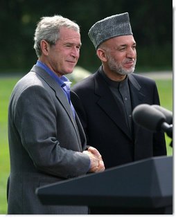 President George W. Bush and Afghanistan President Hamid Karzai shake hands following their address to the media at a joint press availability Monday Aug. 6, 2007, at Camp David near Thurmont, Md. White House photo by Eric Draper