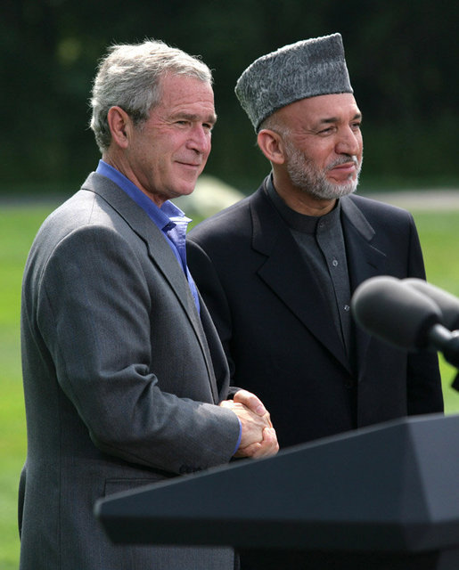 President George W. Bush and Afghanistan President Hamid Karzai shake hands following their address to the media at a joint press availability Monday Aug. 6, 2007, at Camp David near Thurmont, Md. White House photo by Eric Draper