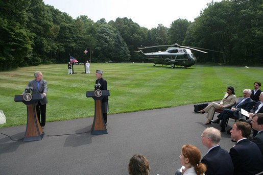 President George W. Bush listens as Afghanistan President Hamid Karzai addresses the media at a joint press availability Monday Aug. 6, 2007, at Camp David near Thurmont, Md., thanking the American people for all that they have done for Afghanistan. White House photo by Chris Greenberg