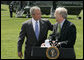 President George W. Bush puts his hand on the shoulder of Karl Rove Monday, August 13, 2007, after the longtime Deputy Chief of Staff and Senior Advisor announced his resignation during a statement on the South Lawn. In thanking Mr. Rove for his service and friendship, the President said, ". I thank my friend. I'll be on the road behind you here in a little bit." White House photo by Joyce N. Boghosian
