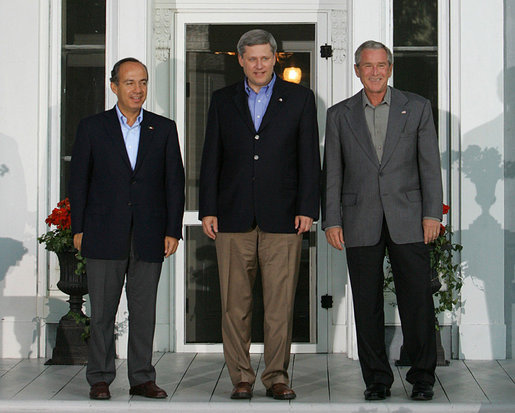 President George W. Bush stands with Mexican President Felipe Calderon, left, and Canadian Prime Minister Stephen Harper upon their arrival for dinner Monday, Aug. 20, 2007, during the North American Leaders' Summit at the Fairmont Le Chateau Montebello in Montebello, Canada. White House photo by Chris Greenberg