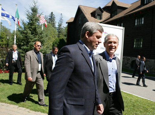 President George W. Bush talks with Canadian Prime Minister Stephen Harper Tuesday, Aug. 21, 2007, following their joint news conference with Mexico’s President Felipe Calderón at the North American Leaders’ Summit in Montebello, Quebec. White House photo by Eric Draper