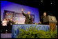President George W. Bush waves to the crowd as he is introduced by Veterans of Foreign Wars National Commander Gary Kurpius Wednesday, Aug. 22, 2007, to the Veterans of Foreign Wars National Convention in Kansas City, Mo. White House photo by Chris Greenberg