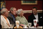 President George W. Bush shares a moment with restaurant owner Leah Chase, center, and fellow dinner guests Dr. Norman Francis, president of Xavier University of Louisiana, left, and Reverend Fred Luter, right, during a dinner with Louisiana cultural and community leaders Tuesday evening, Aug. 28, 2007, at Dooky Chase's restaurant in New Orleans. President Bush and Mrs. Laura Bush are visiting New Orleans and the Gulf Coast region on the second anniversay of Hurricane Katrina. White House photo by Shealah Craighead