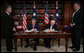 President George W. Bush and Australia's Prime Minister John Howard sign the Defense Cooperation Treaty following a meeting Wednesday, Sept. 5, 2007, at the Commonwealth Parliament Offices in Sydney. White House photo by Eric Draper