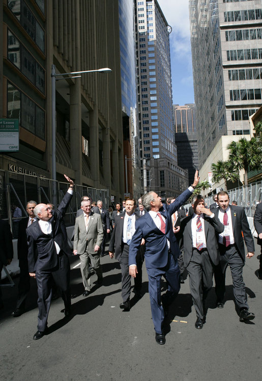 President George W. Bush and Prime Minister John Howard, of Australia, wave to well-wishers Wednesday, Sept. 5, 2007, after leaving the Commonwealth Parliament Offices and walking to the InterContinental Hotel in Sydney. White House photo by Eric Draper