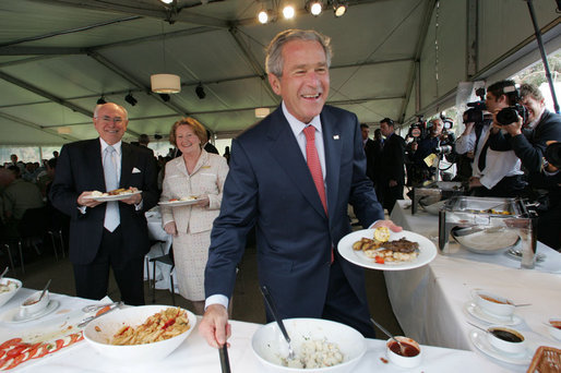 With Australia's Prime Minister John Howard and his wife, Janette Howard, smiling in the background, President George W. Bush kids with members of the media Wednesday, Sept. 5, 2007, during a luncheon with Australian troops on Garden Island in Sydney. White House photo by Chris Greenberg