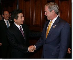 President George W. Bush welcomes President Roh Moo-hyun of the Republic of Korea, to a meeting Friday, Sept. 7, 2007, at the InterContinental hotel in Sydney. President Bush told his counterpart, ".When we have worked together, we have shown that it's possible to achieve the peace on the Korean Peninsula that the people long for. So thank you, sir."  White House photo by Eric Draper