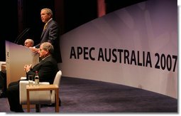 President George W. Bush speaks to the APEC Business Summit Friday, Sept. 7, 2007, at the Sydney Opera House. Joining him on stage are Australia's Prime Minister John Howard, far left, and Mark Johnson, Chairman of the APEC Business Advisory Council. White House photo by Chris Greenberg