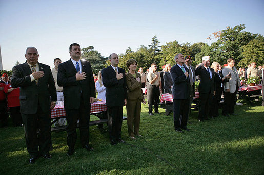 President George W. Bush and Laura Bush stand for the singing of the national anthem during a visit with military support organizations Tuesday, Sept. 18, 2007, on the South Lawn. White House photo by Eric Draper