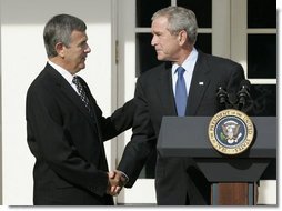 President George W. Bush shakes the hand of Mike Johanns, resigning Secretary of Agriculture, after he announced the secretary's decision to return to his home state of Nebraska during a morning statement in the Rose Garden. White House photo by Joyce N. Boghosian