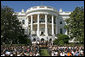 President George W. Bush addresses the NCAA 2006 and 2007 championship Teams during a ceremony Friday, Sept. 21, 2007, on the South Lawn. "Because you're a champ on the field, you have a chance to inspire somebody to make right choices in life," said President Bush in his remarks. "You have the opportunity to set a good example. You don't know how many youngsters are looking at you, but there's a lot. People are wondering how champs behave. So by setting high standards and working hard to achieve them, you're influencing other people." White House photo by Chris Greenberg