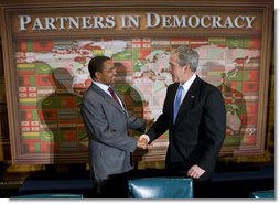 President George W. Bush shakes hands with Tanzania President Jakaya Kikwete during their participation in a Roundtable on Democracy Tuesday, Sept. 25, 2007, at the United Nations in New York. White House photo by Eric Draper
