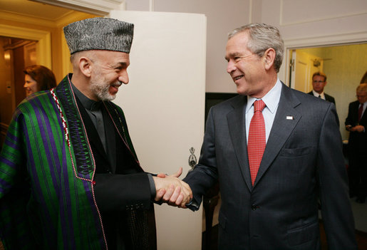 President George W. Bush welcomes Afghanistan President Hamid Karzai to a meeting at the Waldorf Astoria Hotel Wednesday morning, Sept. 26, 2007 in New York. The two leaders met following their participation in meetings at the United Nations. White House photo by Eric Draper