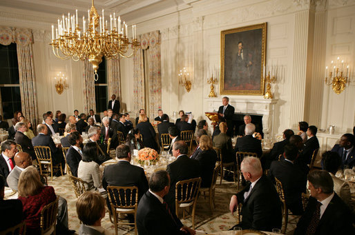 President George W. Bush welcomes guests to the Iftaar Dinner with Ambassadors and Muslim leaders in the State Dining Room of the White House, Thursday, Oct. 4, 2007. White House photo by Chris Greenberg