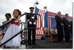 Athen Schwantes, left, joins her daughter as they listen to the invocation during a ceremony at the National Fallen Firefighters Memorial in Emmitsburg, Md., Sunday, Oct. 7. 2007. White House photo by Chris Greenberg