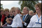 President George Bush holds 8-year-old Turner Koyle of Holden, Utah, during a ceremony at the National Fallen Firefighters Memorial in Emmitsburg, Md., Sunday, Oct. 7, 2007. White House photo by Chris Greenberg