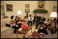 President George W. Bush meets with Yamile Llanes Labrada and her daughter Shirln Garcia, pictured sitting immediately to her mother's right, Wednesday, Oct. 10, 2007, in the Oval Office. Mrs. Labrada is the wife of Cuban political prisoner Dr. Jose Luis Garcia Paneque. White House photo by Eric Draper