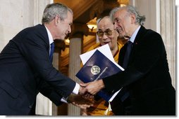 President George W. Bush, joined by The Dalai Lama, welcomes Nobel Peace Laureate Elie Wiesel, Wednesday, Oct. 17, 2007, to the ceremony at the U.S. Capitol in Washington, D.C., for the presentation of the Congressional Gold Medal to The Dalai Lama. White House photo by Chris Greenberg