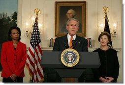 Flanked by Secretary of State Condoleezza Rice and Mrs. Laura Bush, President George W. Bush delivers a statement at the White House Friday, Oct. 19, 2007, regarding sanctions on Burma. Said the President, "The people of Burma are showing great courage in the face of immense repression. They are appealing for our help. We must not turn a deaf ear to their cries." White House photo by Chris Greenberg