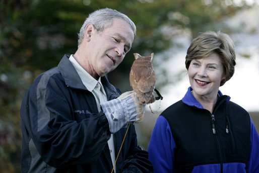 President George W. Bush and Mrs. Laura Bush have a close look at a screech owl Saturday, Oct. 20, 2007 at the Patuxent Research Refuge in Laurel, Md., where President Bush discussed steps his Administration is creating for a series of cooperative conservation steps to preserve and restore critical stopover habitat for migratory birds in the United States. White House photo by Eric Draper