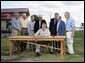 President George W. Bush signs an Executive Order to protect the striped bass and red drum fish populations Saturday, Oct. 20, 2007, at the Chesapeake Bay Maritime Museum in St. Michaels, Md. President Bush is joined during the signing by, from left, Michael Nussman, president of American Sportfishing Association; Brad Burns, president of Stripers Forever; David Pfeifer, president of Shimano America Corp.; Walter Fondren, chairman of Coastal Conservation Association; U.S. Secretary of Commerce Carlos Gutierrez; U.S. Rep. Wayne Gilchrest of Maryland and U.S. Secretary of Interior Dirk Kempthorne. White House photo by Eric Draper