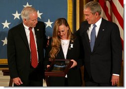 President George W. Bush stands with Dan and Maureen Murphy, parents of Lt. Michael P. Murphy, after the Navy SEAL was honored posthumously with the Medal of Honor during ceremonies Monday, Oct. 22, 2007, in the East Room of the White House. White House photo by Joyce N. Boghosian