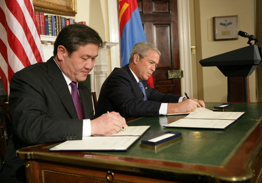 President George W. Bush and President Nambaryn Enkhbayar of Mongolia sign the Millennium Challenge Corporation Compact Monday, Oct. 22, 2007, in the Roosevelt Room of the White House. White House photo by Chris Greenberg