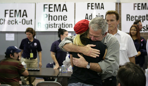 President George W. Bush hugs an unidentified woman Thursday, Oct. 25, 2007, at a FEMA emergency center in Rancho Bernardo, California. The President visited the Southern California area hard hit by recent wildfires, consoling those who lost their homes and commending those whose efforts saved others. White House photo by Eric Draper